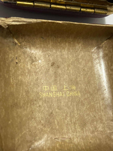 Close-up of the interior box with gold text reading Shanghai China in vintage watch packaging